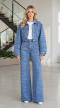 Full front view of model wearing Denim Blue croc-embossed cropped jacket and wide-leg denim pants set