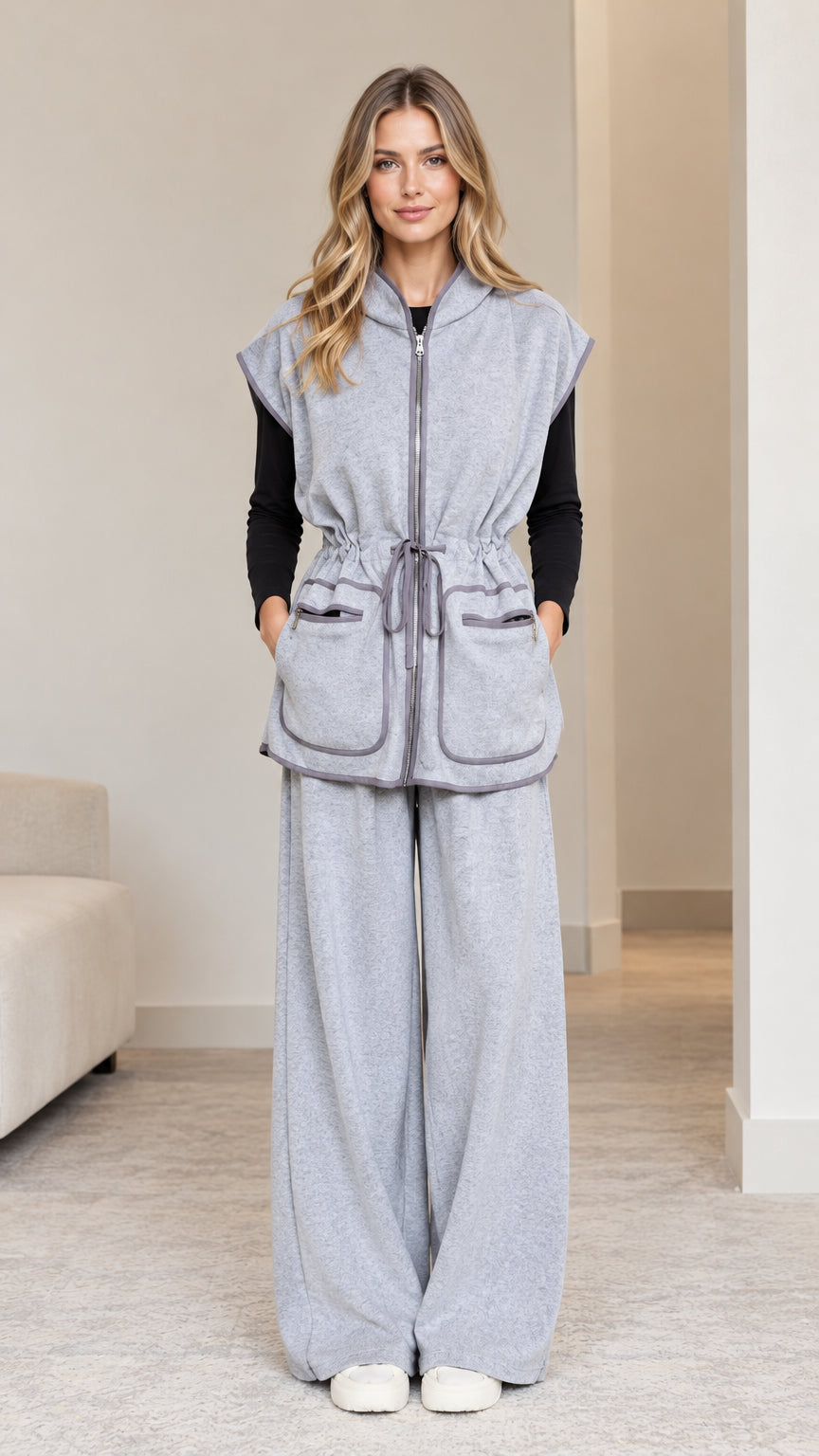 Front full-length view of model wearing heather grey sleeveless hooded vest and wide-leg pants set