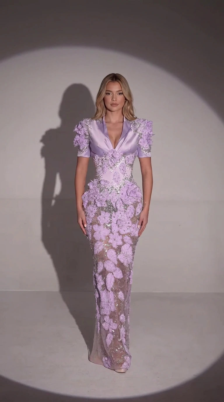 Front full-length view of model wearing lavender 3D floral embellished evening gown