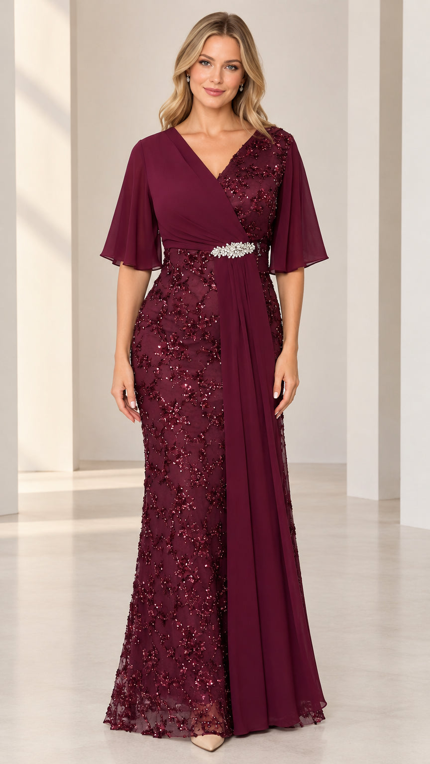 Front full-length view of model wearing burgundy sequin embroidered flutter sleeve evening gown