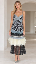 Front view of model wearing zebra print cami midi dress in black with feather and lace hem