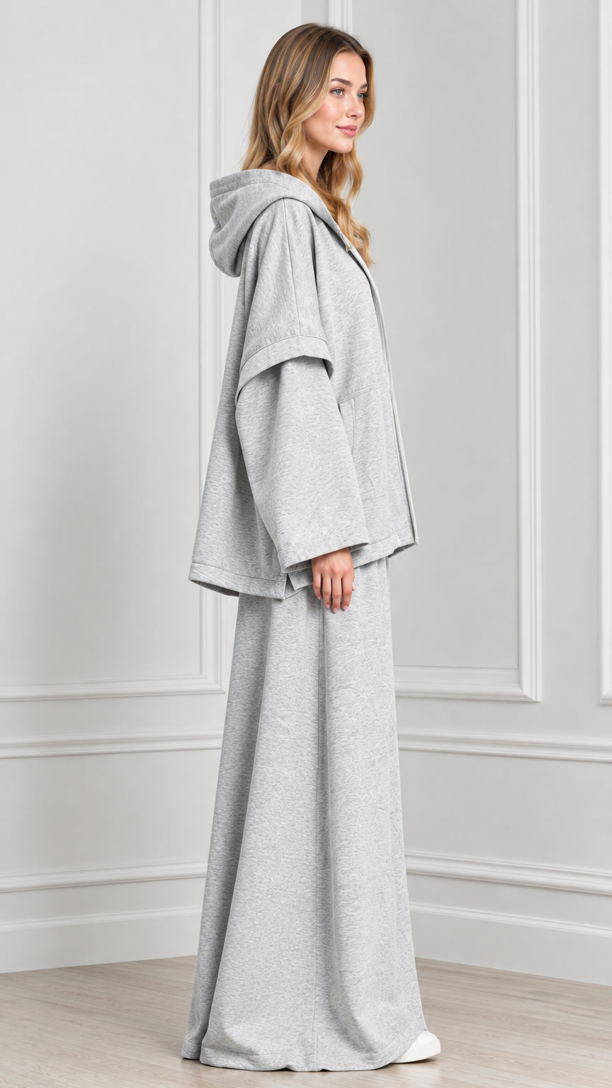 Side profile of woman wearing Heather Grey hooded cape jacket matching pants set