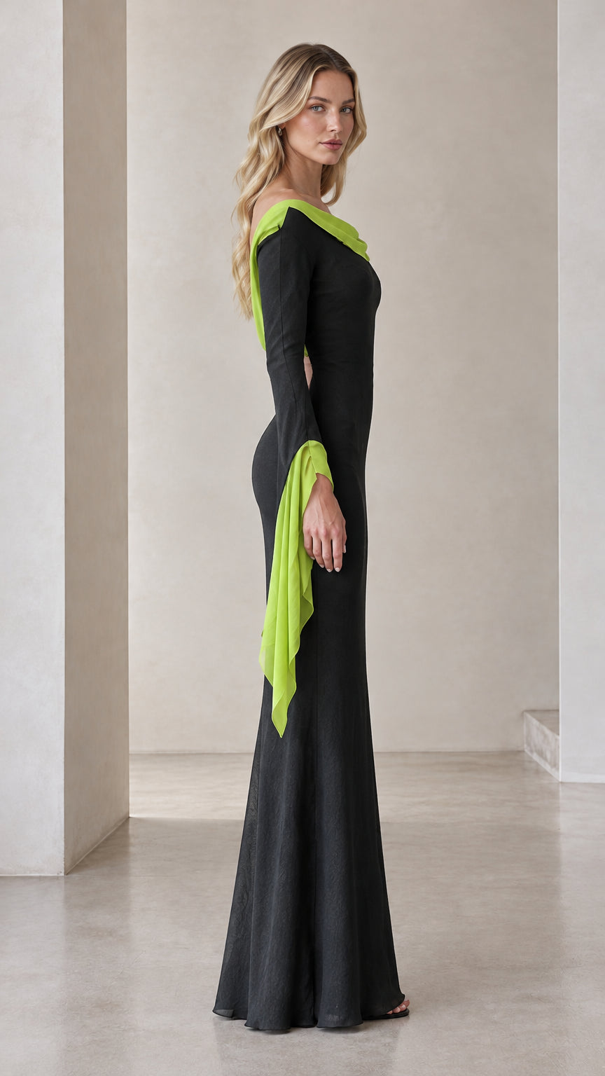 Side profile view of the black evening gown with draped sleeves