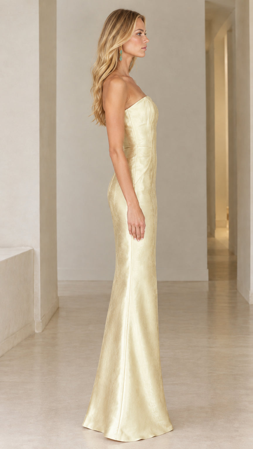 Side profile view of champagne strapless floor-length evening dress