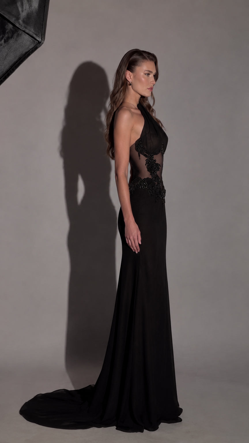 Side profile of black one-shoulder formal maxi dress showing silhouette and sweep train
