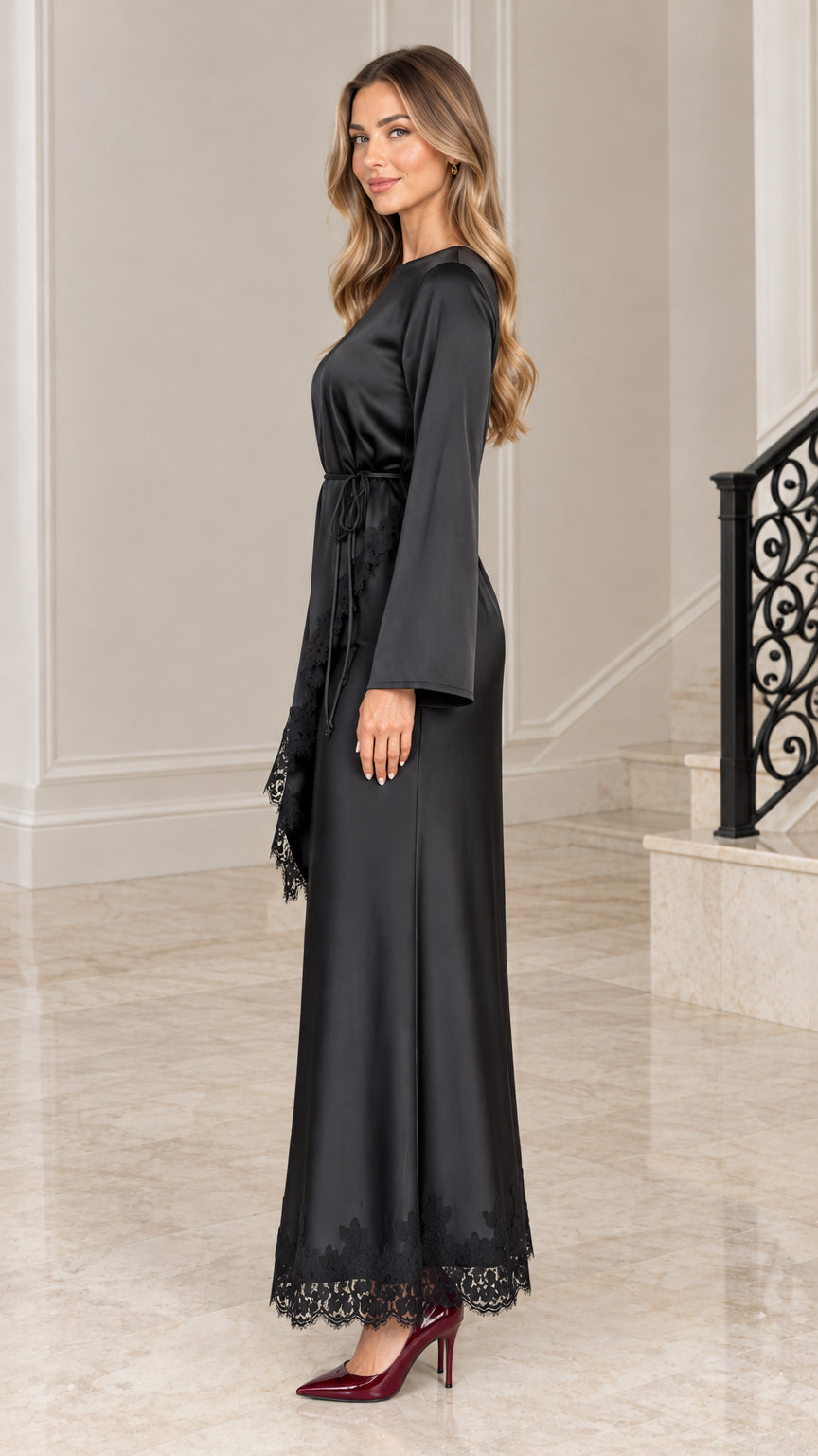 Side profile view of black satin long sleeve maxi gown