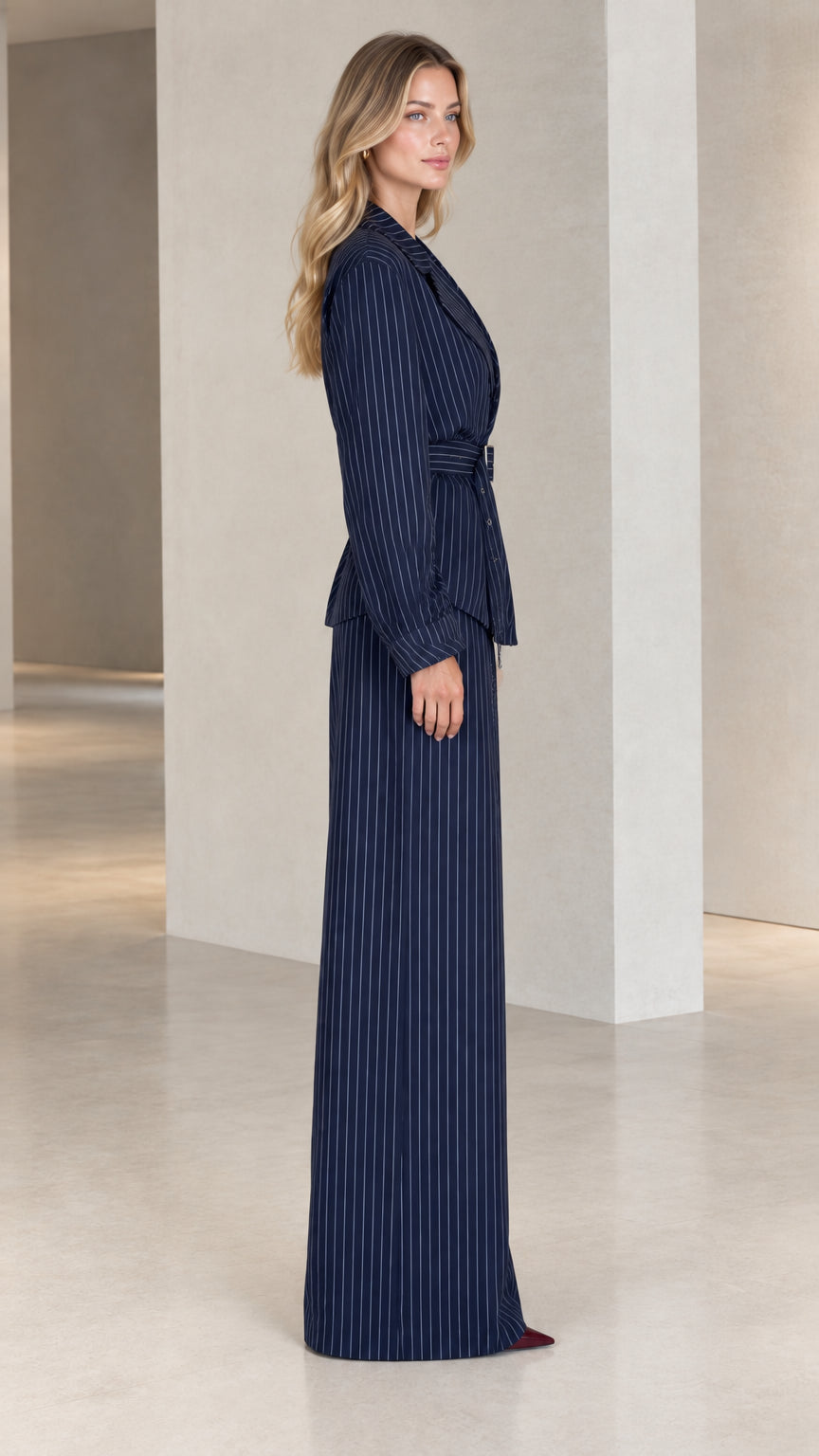 Side profile view of model in Navy Blue pinstripe two-piece tailored suit set