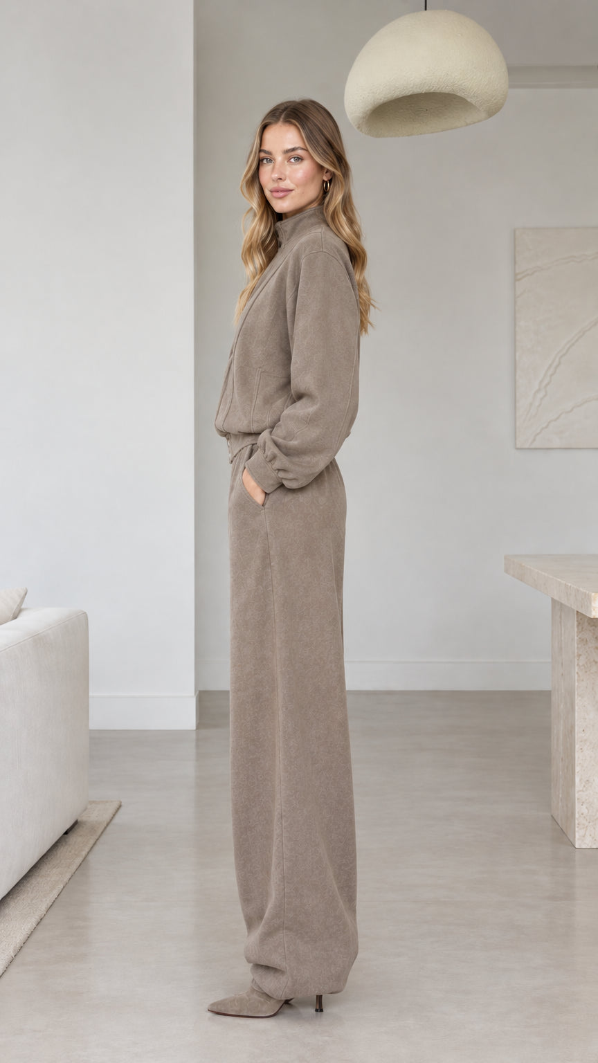 Side view of woman wearing taupe wide-leg casual two-piece tracksuit
