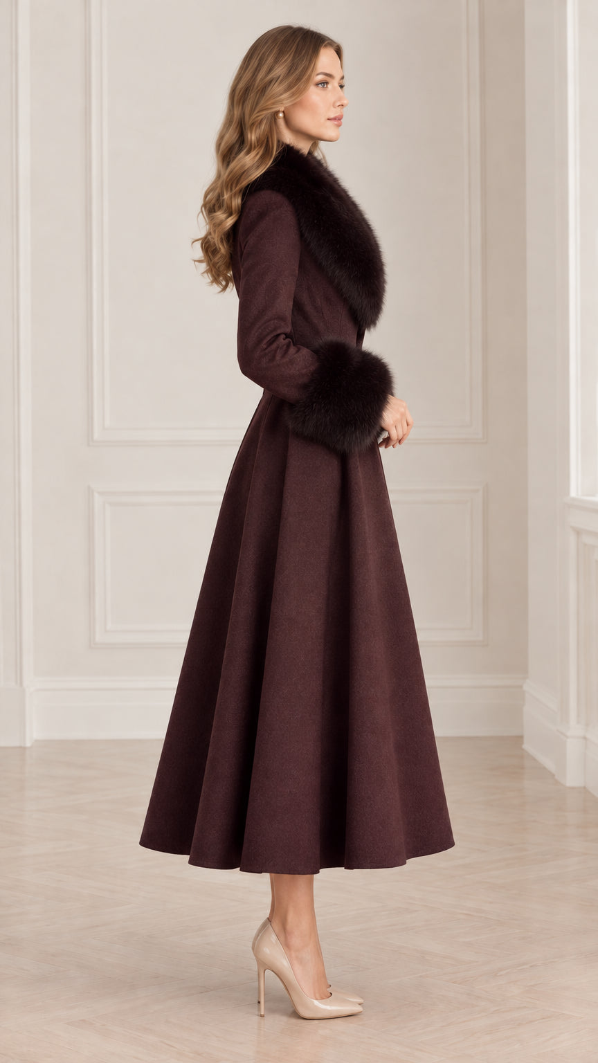 Side profile view of model wearing Burgundy flared midi coat with faux fur collar and cuffs