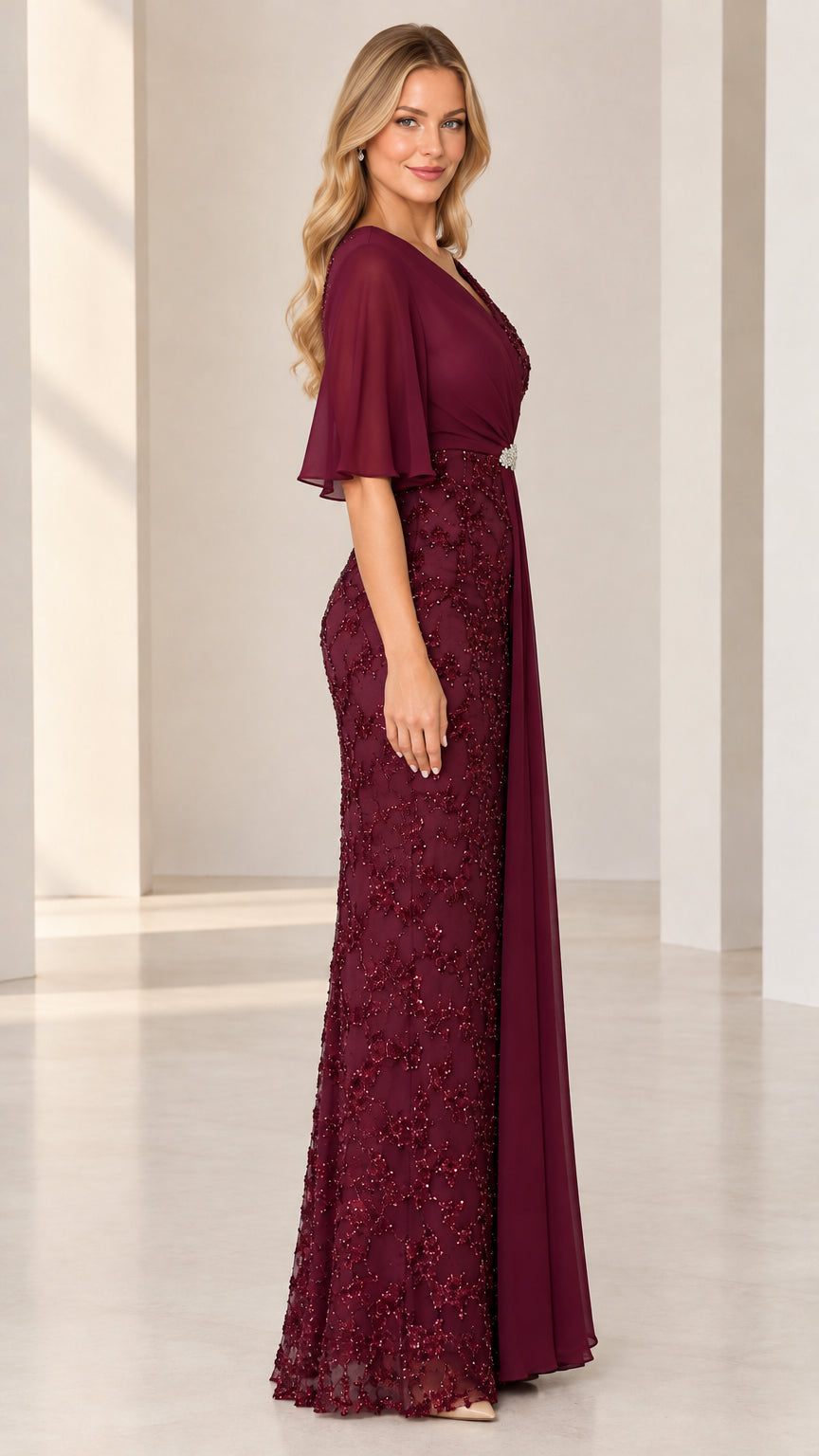 Side profile view of burgundy flutter sleeve formal maxi dress with cascading drape