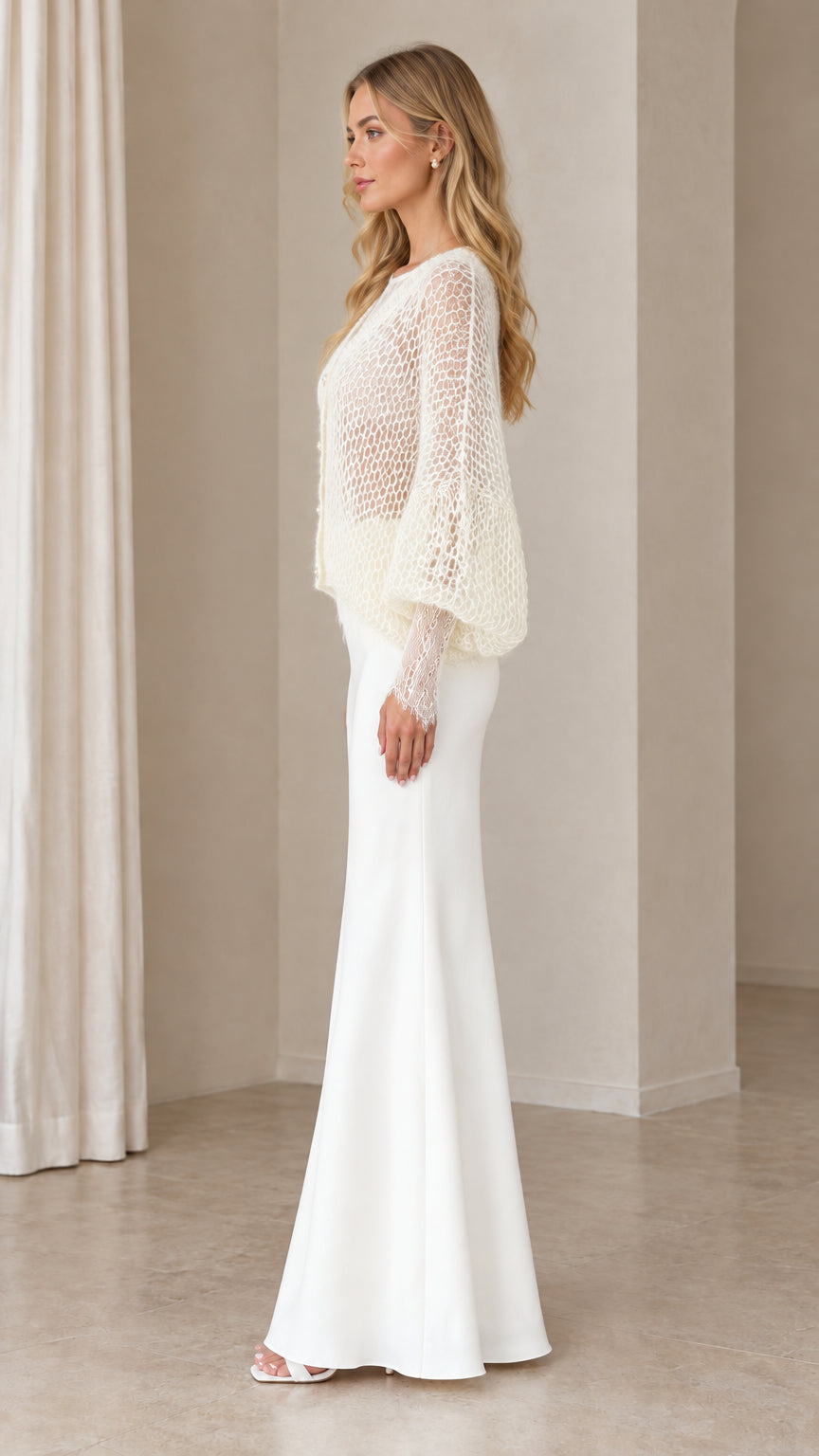 Side profile view of woman wearing Ivory open-knit cardigan and floor-length skirt