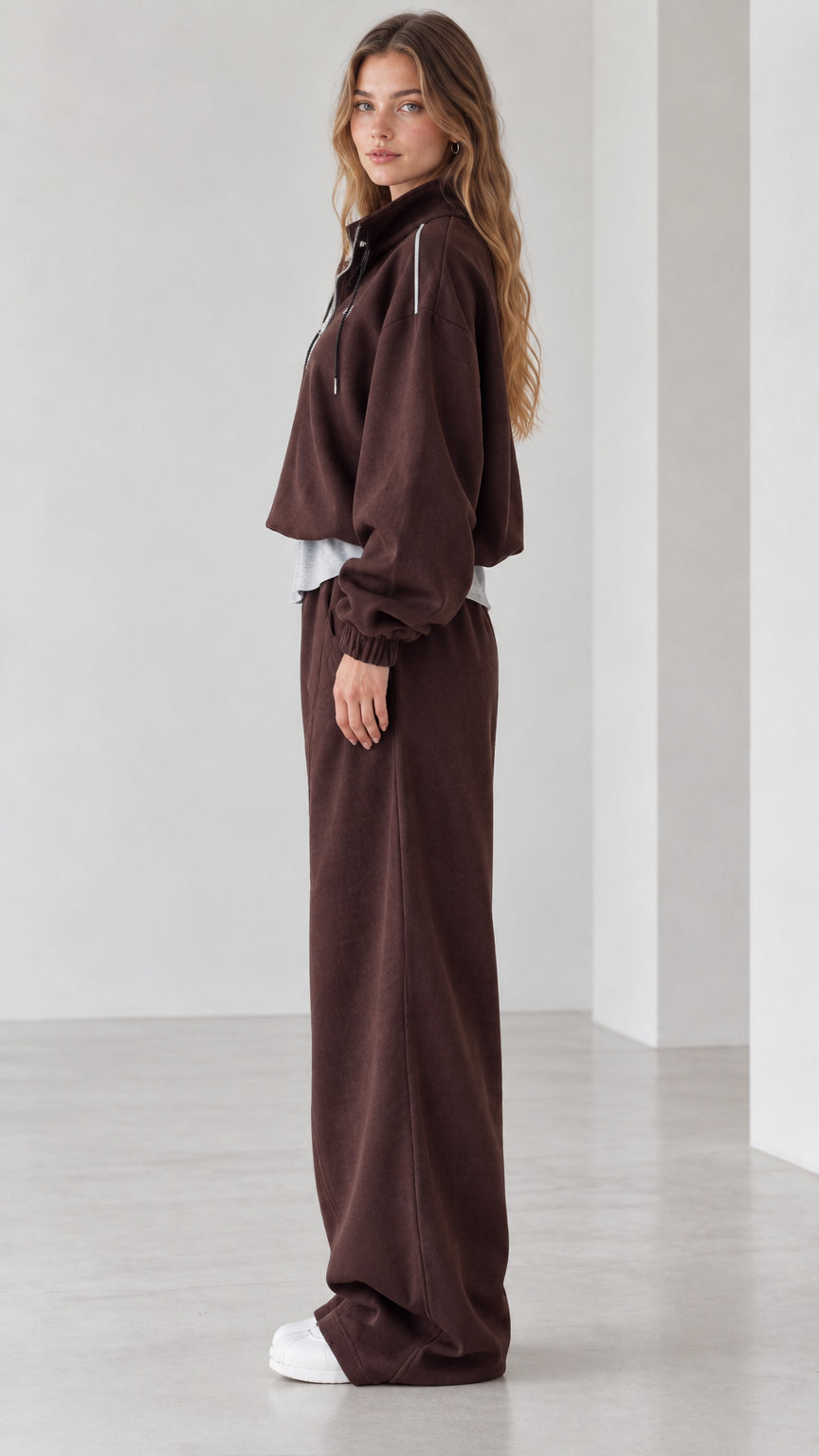 Side profile view of chocolate brown two-piece loungewear set with wide-leg pants