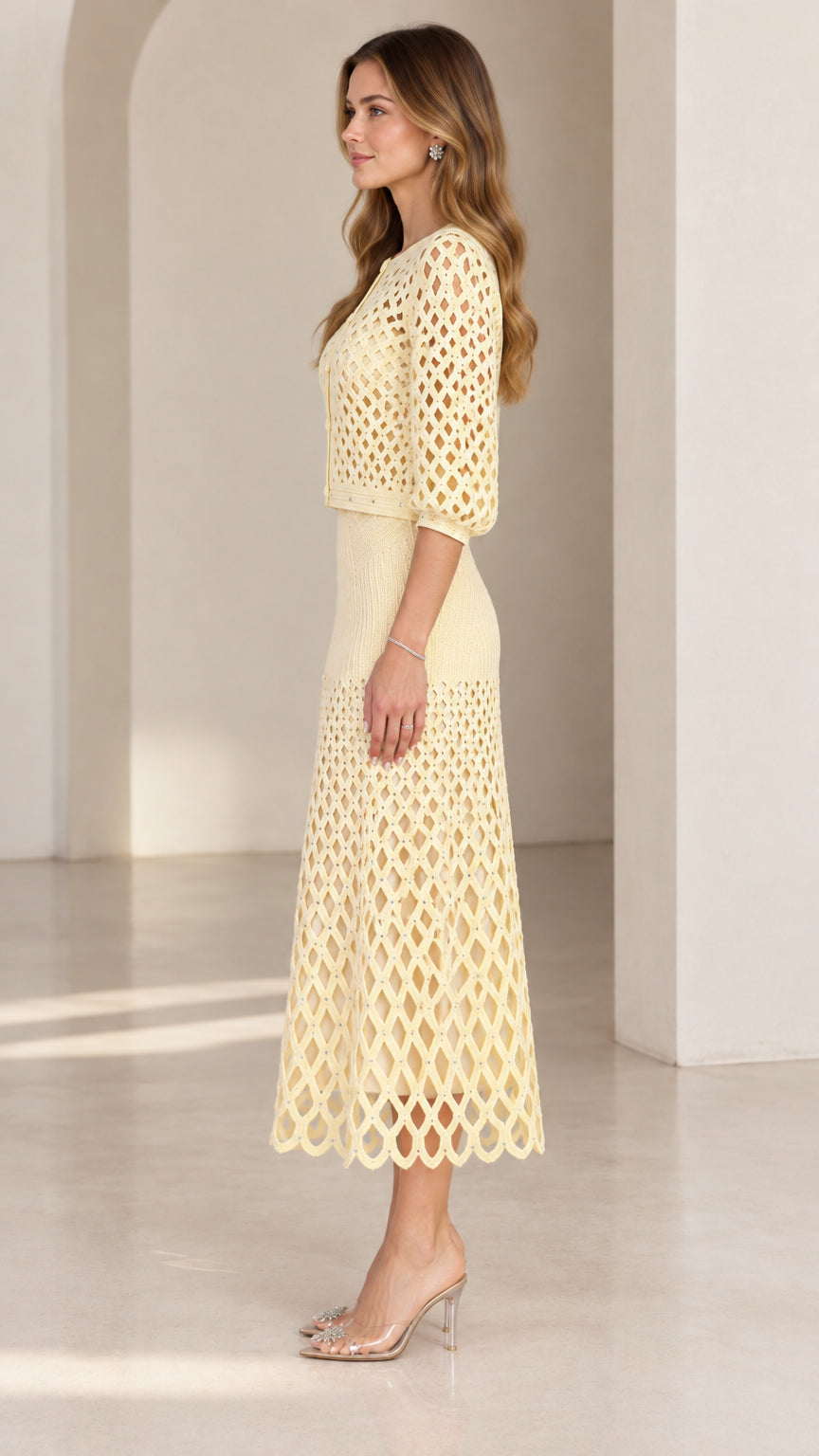 Side profile view of pale yellow knit two-piece skirt set