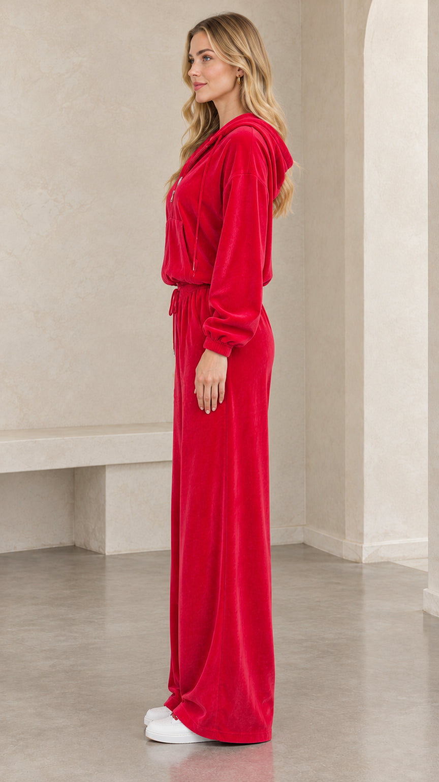 Side profile of woman in red velour matching lounge set