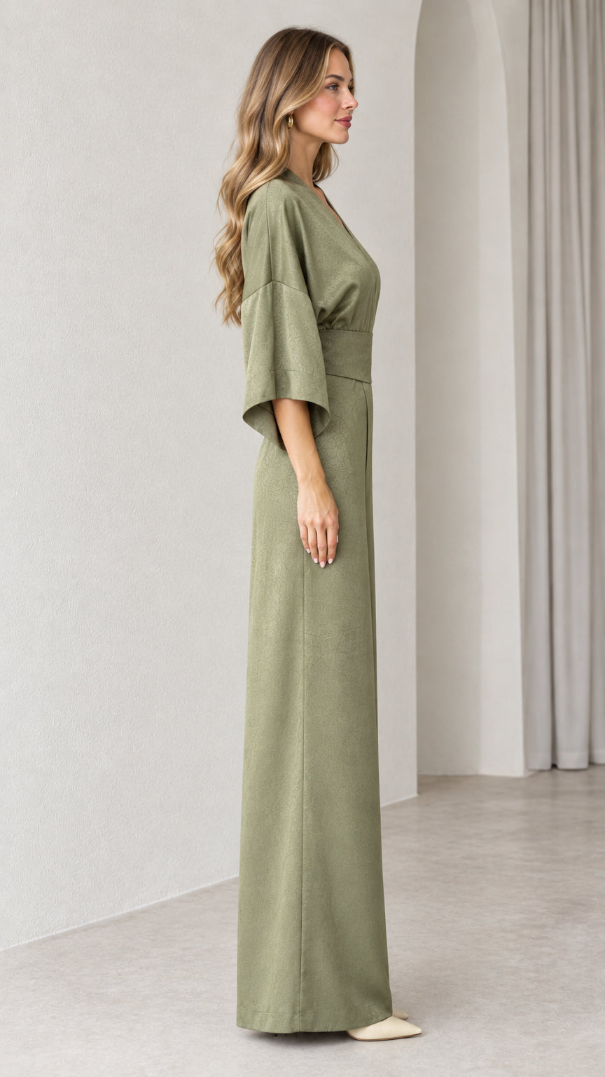 Side profile view of Sage Green wide leg jumpsuit showing drape and silhouette