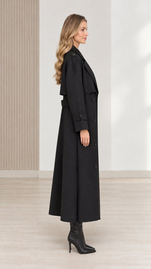 Side view of women's black long trench coat with belt