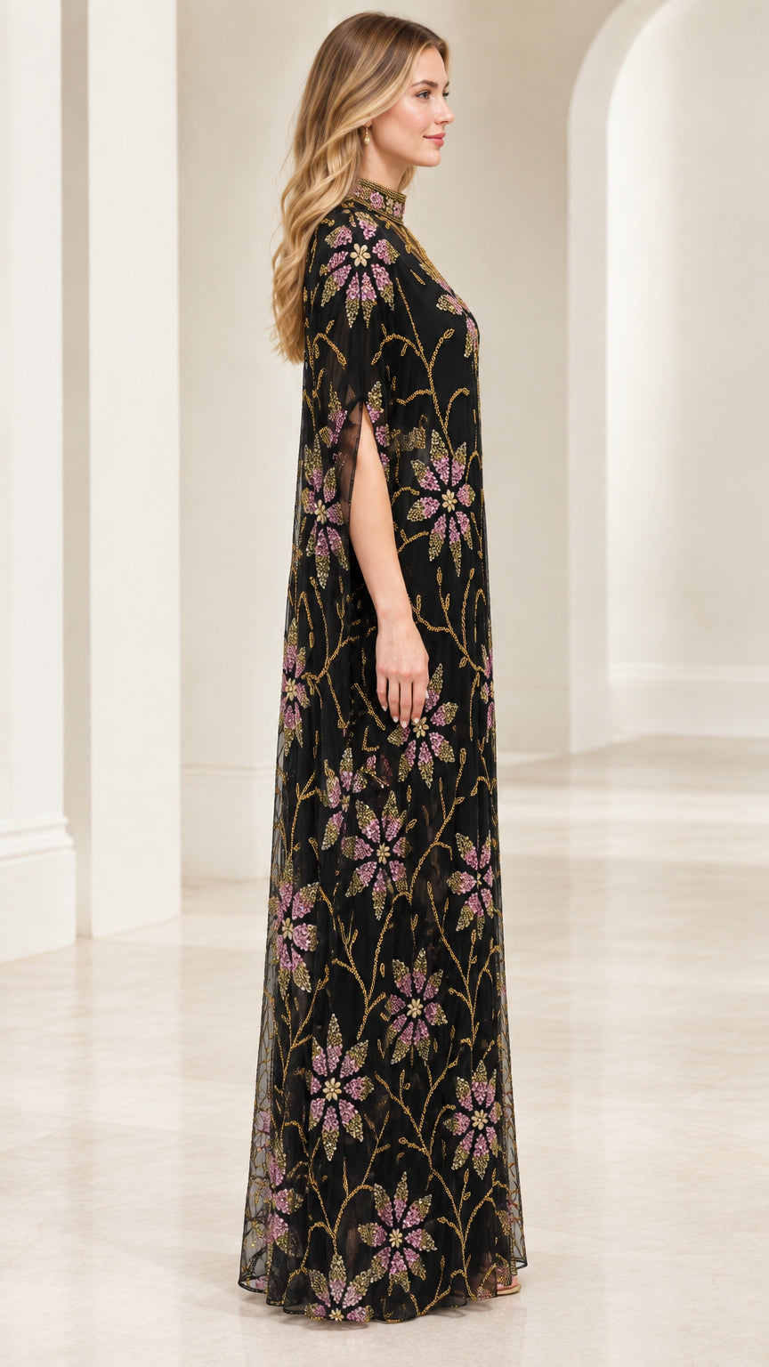 Side view of black cape gown showing split sleeve detail and flowing drape