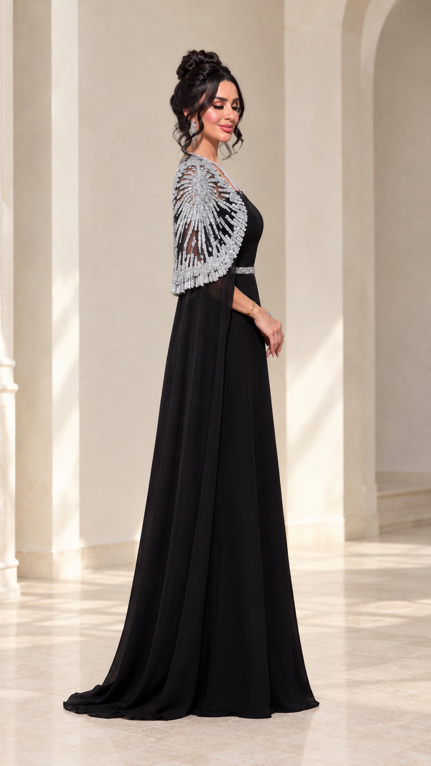 Side view of black formal A-line gown with sequin embellished capelet