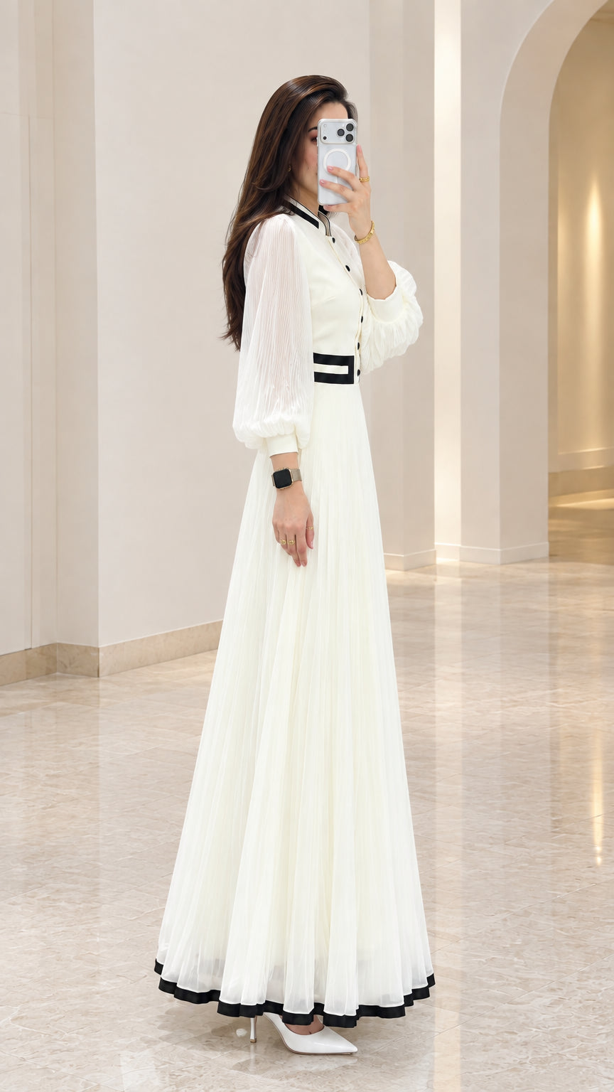 Side profile view of white long sleeve pleated maxi evening dress