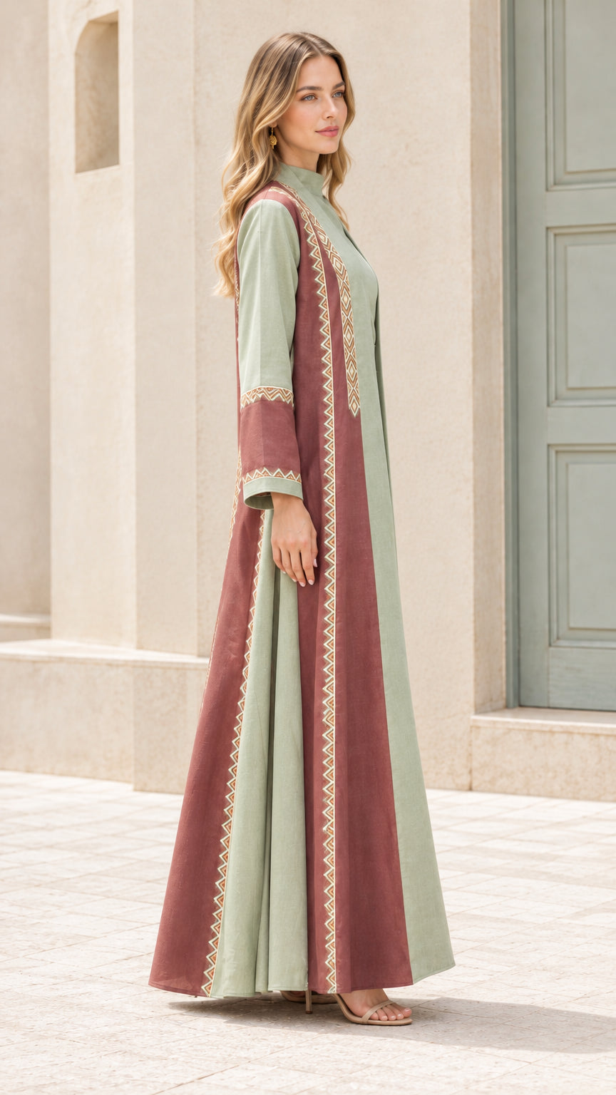 Side profile of model wearing sage green and rust color block maxi abaya set