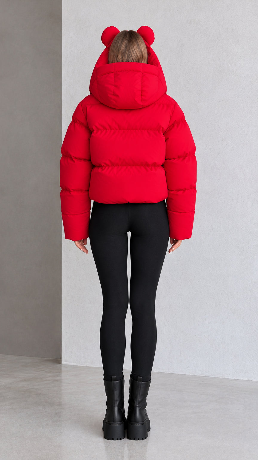 Back view of model showing red quilted cropped puffer jacket and bear ear hood