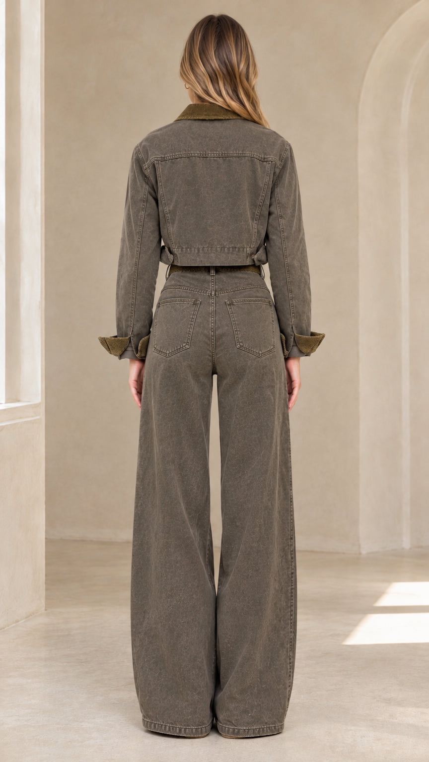 Back view of model in olive green cropped denim jacket and wide-leg trousers