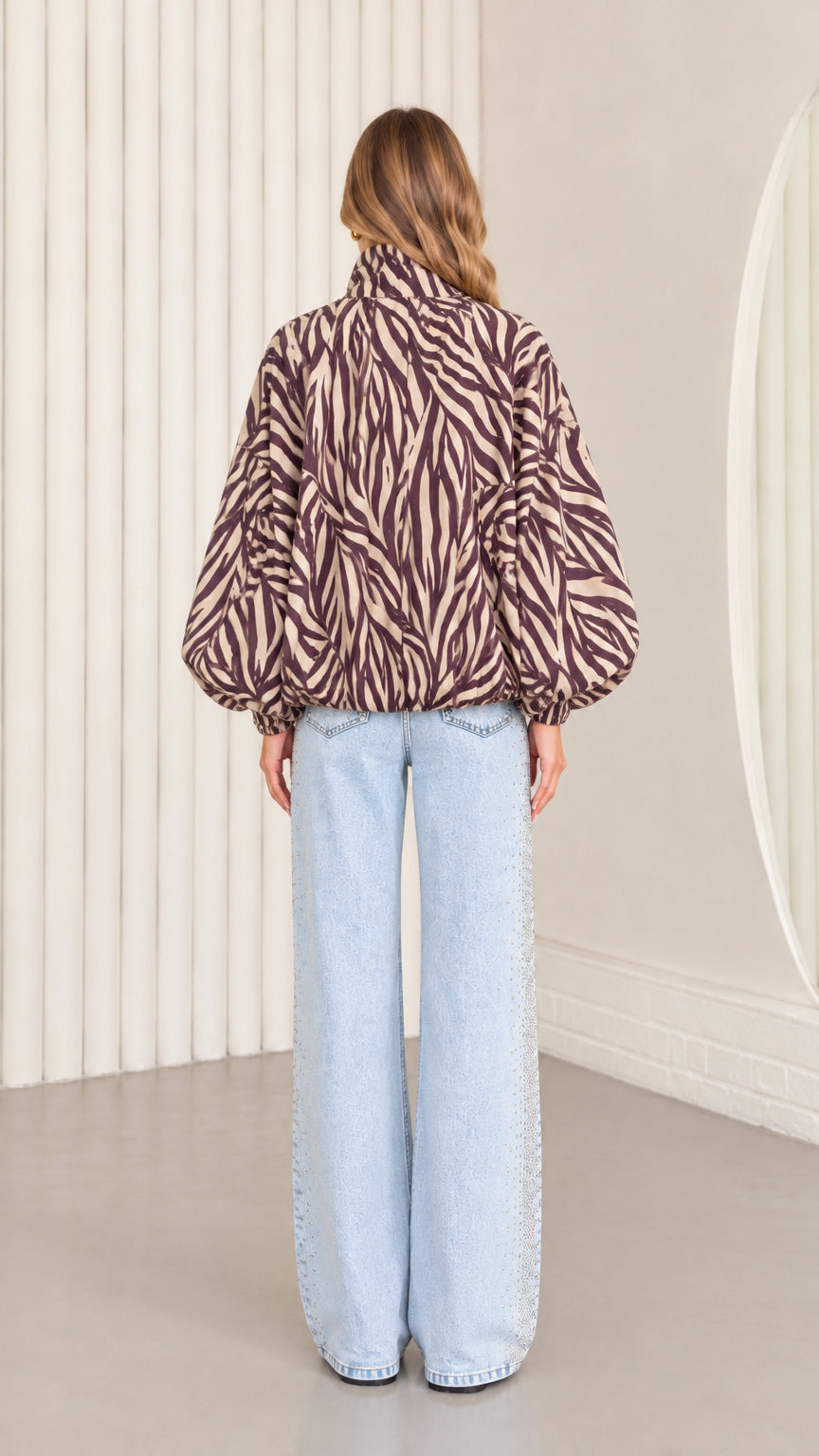 Back view of model wearing mocha brown zebra print lightweight blouson jacket