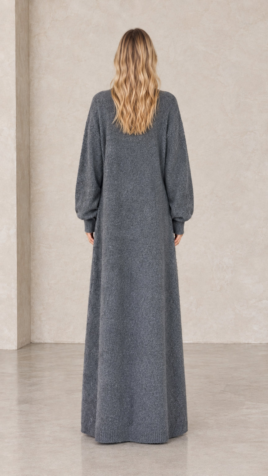 Back full-length view of woman in charcoal grey maxi duster cardigan