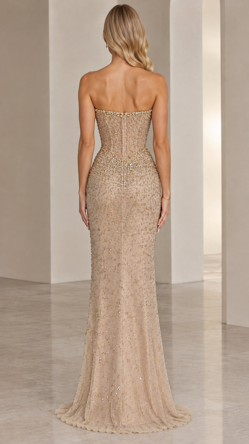 Back view of model wearing Champagne beaded strapless floor-length gown