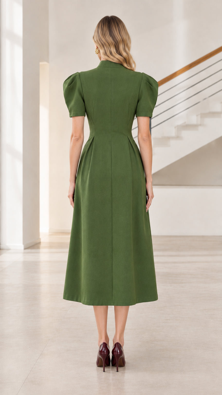Back view of model wearing olive green fit and flare midi dress with concealed zipper