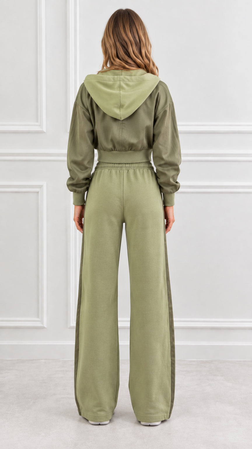 Back view of woman wearing olive green cropped hoodie with hood and matching wide-leg pants
