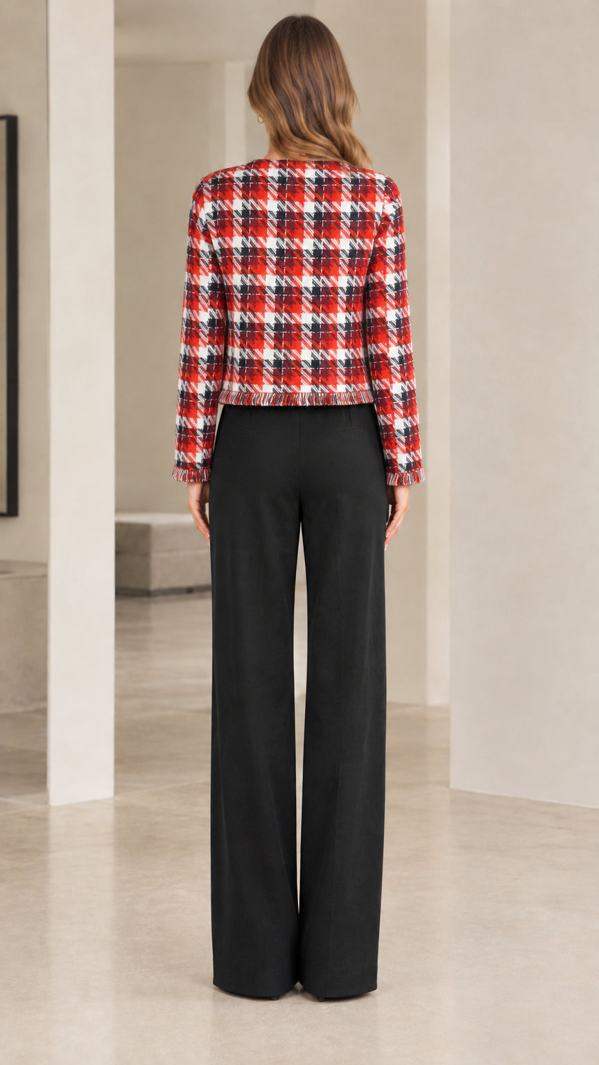 Back view of model wearing collarless red plaid tweed jacket