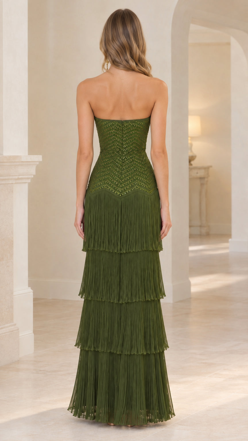 Back view of woman wearing olive green strapless sequin and tiered fringe maxi dress
