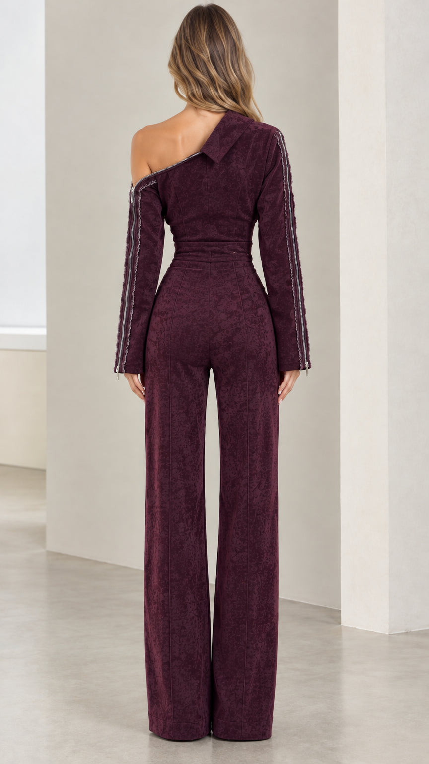 Back view of model in Burgundy asymmetric one-shoulder wide-leg jumpsuit