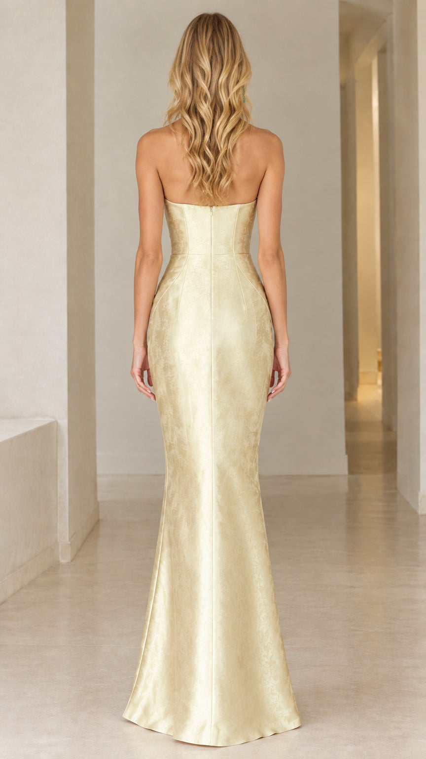 Back full-length view of champagne strapless gown showcasing fitted back silhouette
