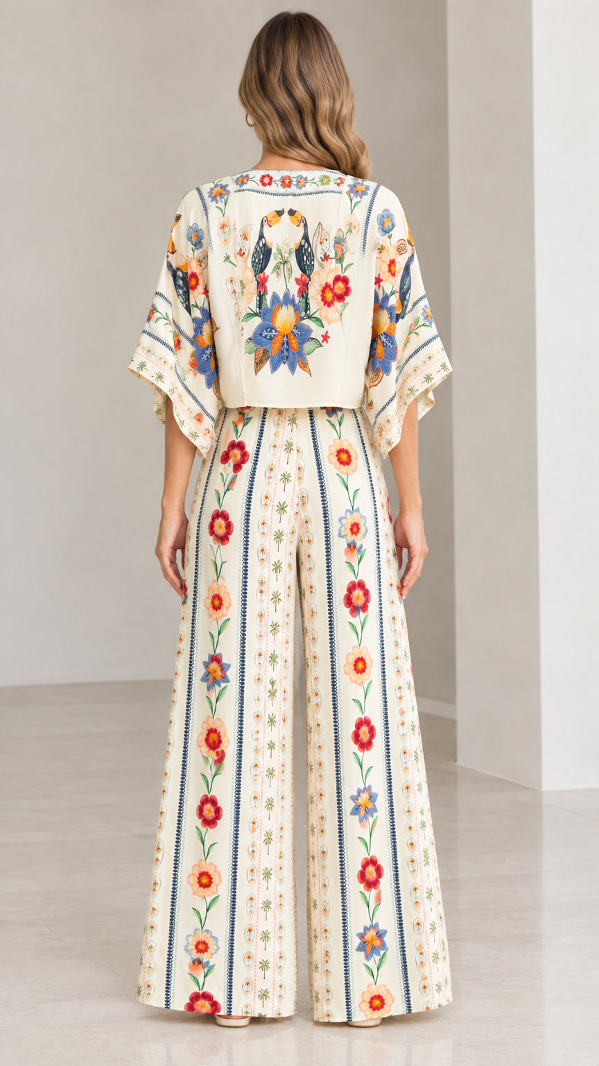 Back view of model showing print detail of cream floral wide-leg pants set