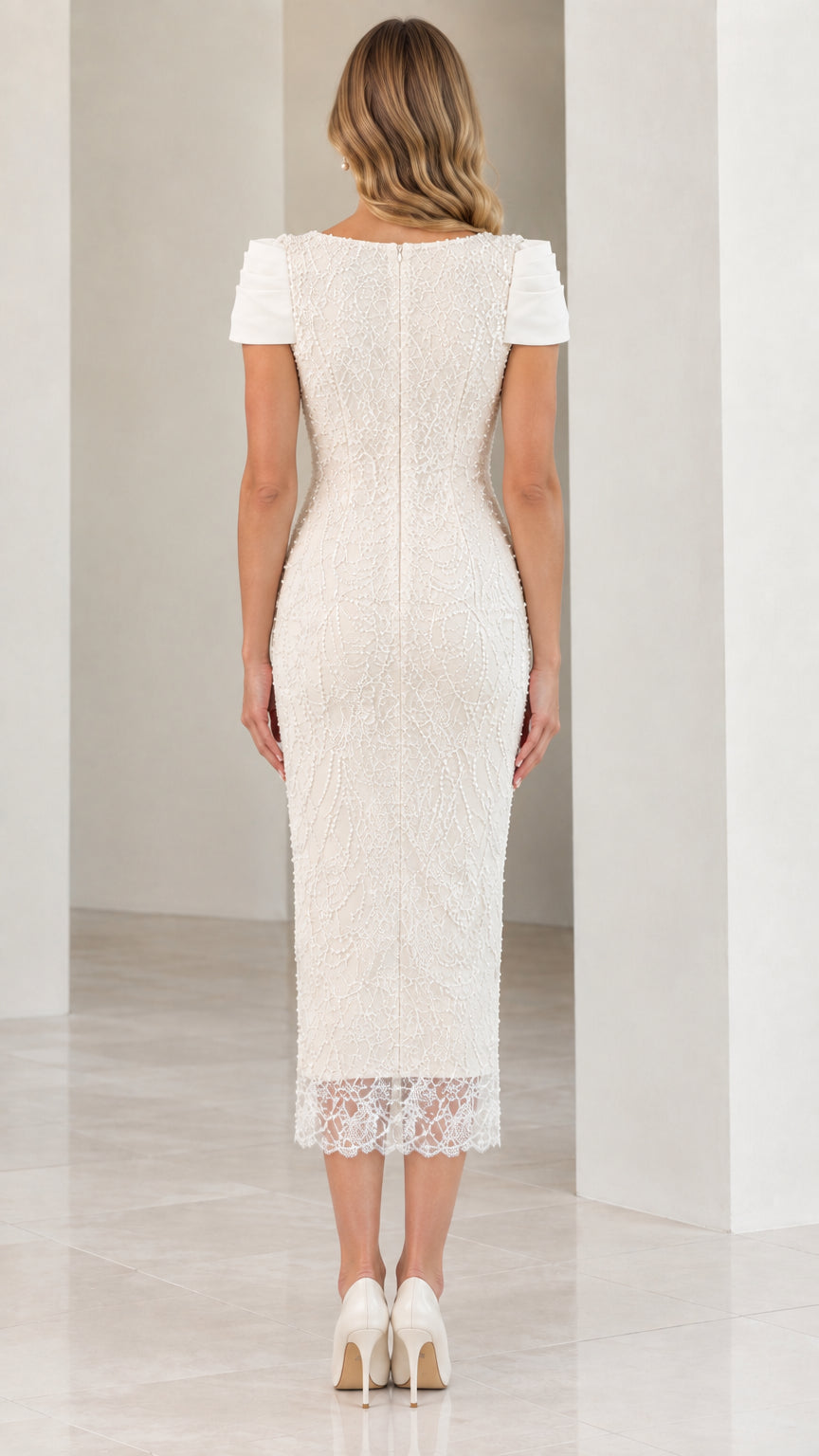 Back view of woman wearing Ivory beaded midi dress showing back zipper and walking slit
