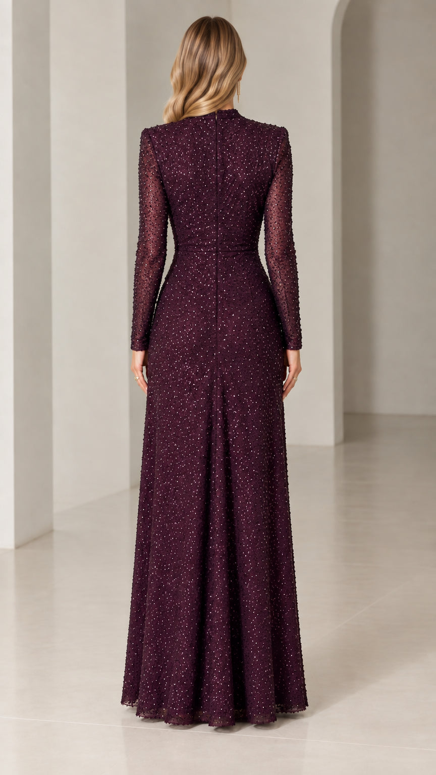 Back view of woman wearing burgundy sequined long-sleeve evening gown