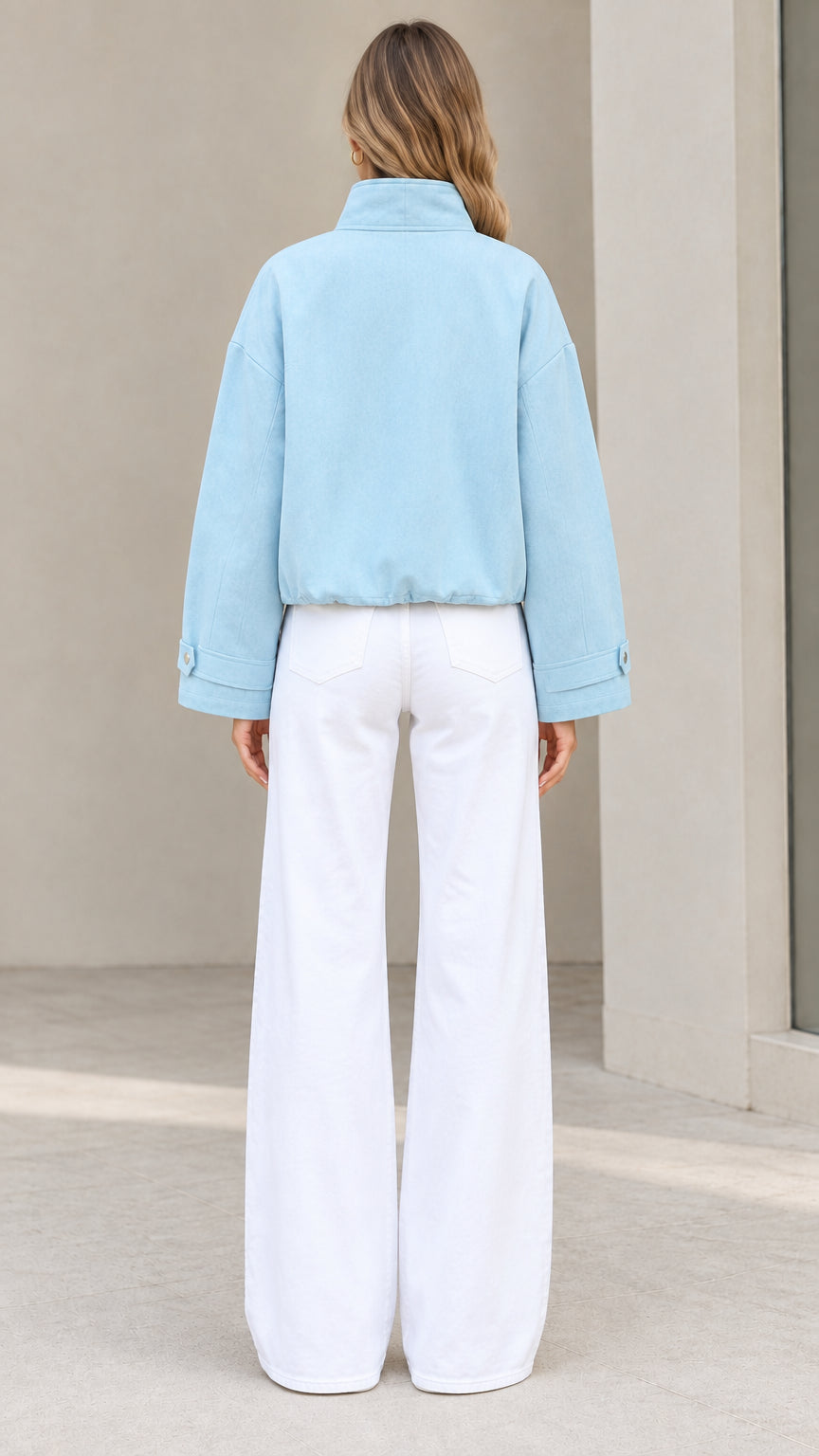 Back full-length view of woman wearing Light Blue jacket with elasticated hem