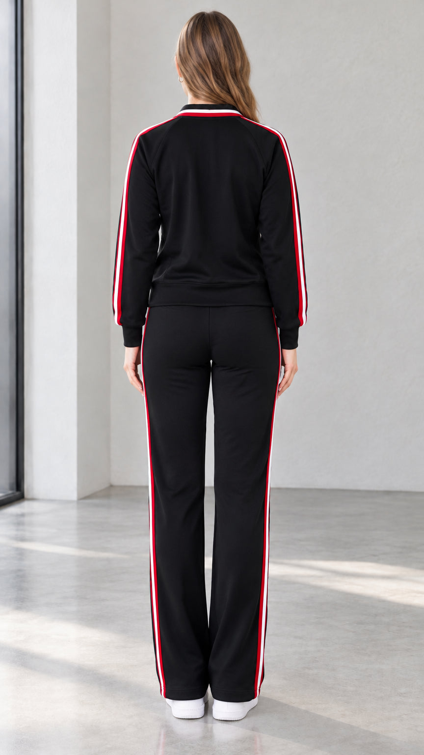 Back view of black sporty track jacket and matching straight pants