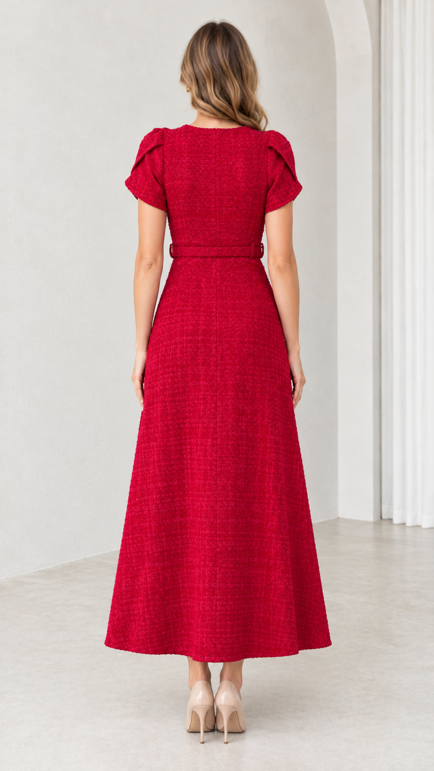 Back view of woman wearing tailored red A-line midi dress with matching belt