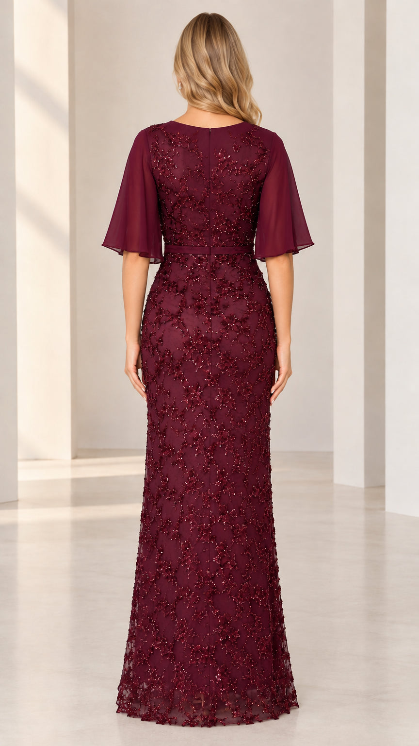 Back full-length view showing V-back cut and floral sequin pattern on burgundy evening gown