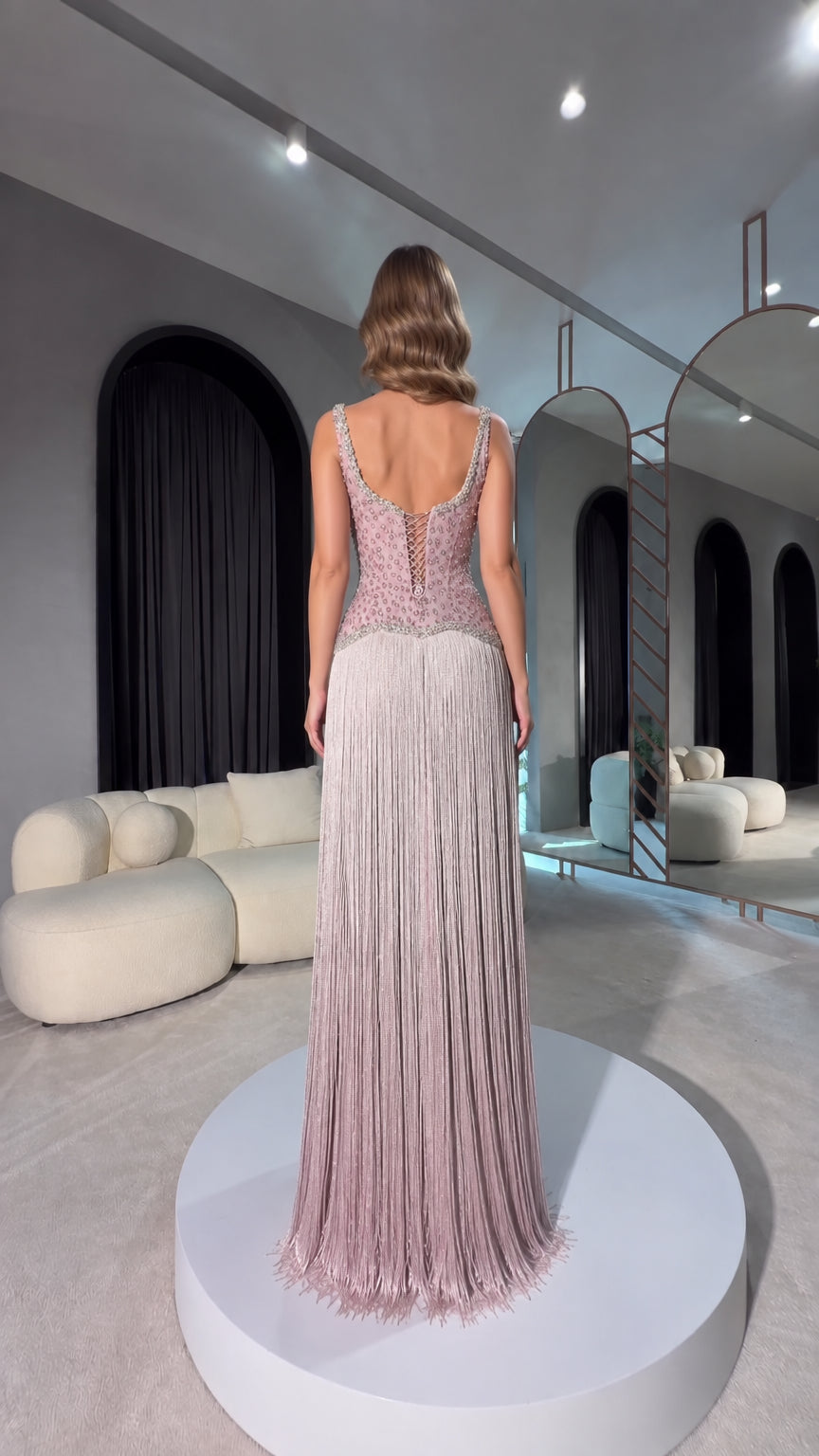 Back view of dusty mauve gown showing lace-up corset detail and fringe skirt
