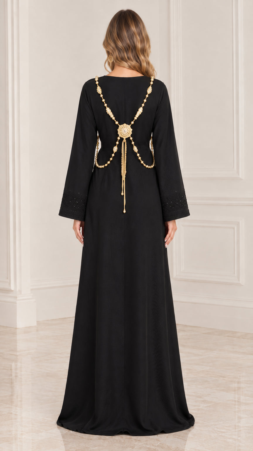 Back view of black kaftan dress showing ornate gold-tone chain back drape