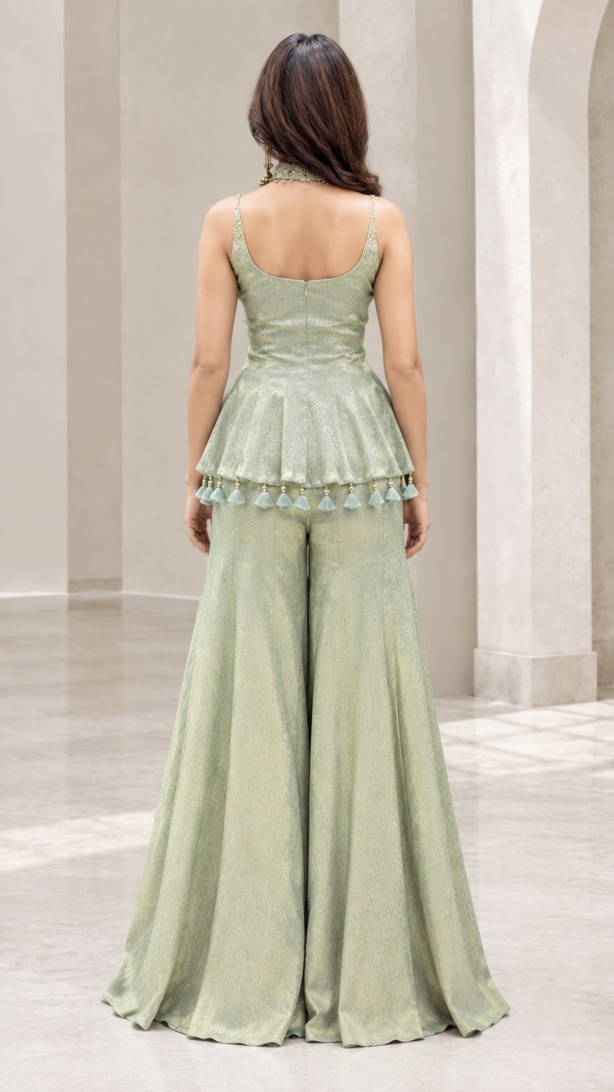 Back full view of woman wearing sage green peplum sharara set