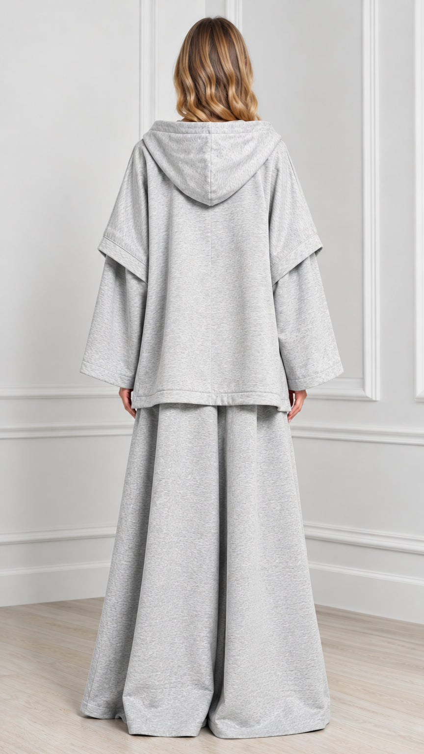 Back view of woman wearing Heather Grey hooded cape lounge set with hood detail