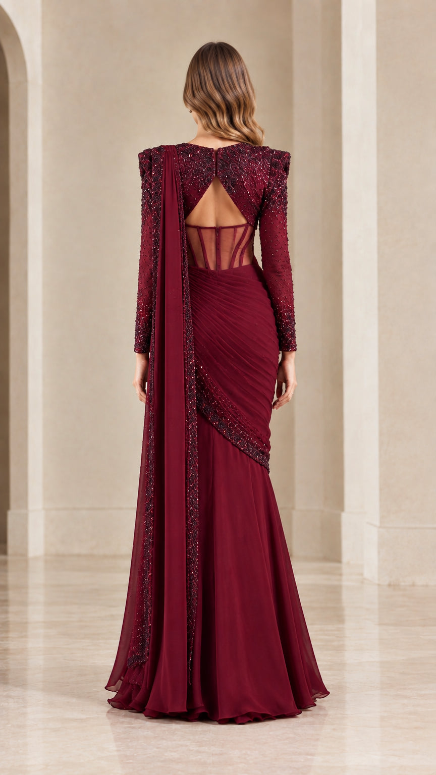 Back view of burgundy formal gown featuring sheer cut-out back and elegant shoulder cape drape
