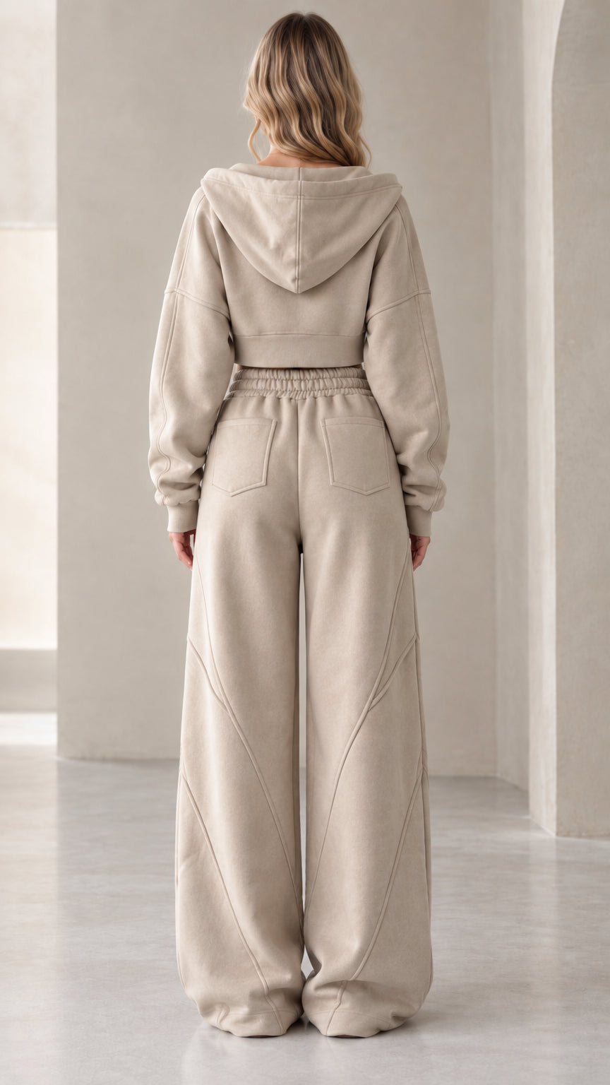 Back view of model in oatmeal cropped hoodie and wide-leg sweatpants