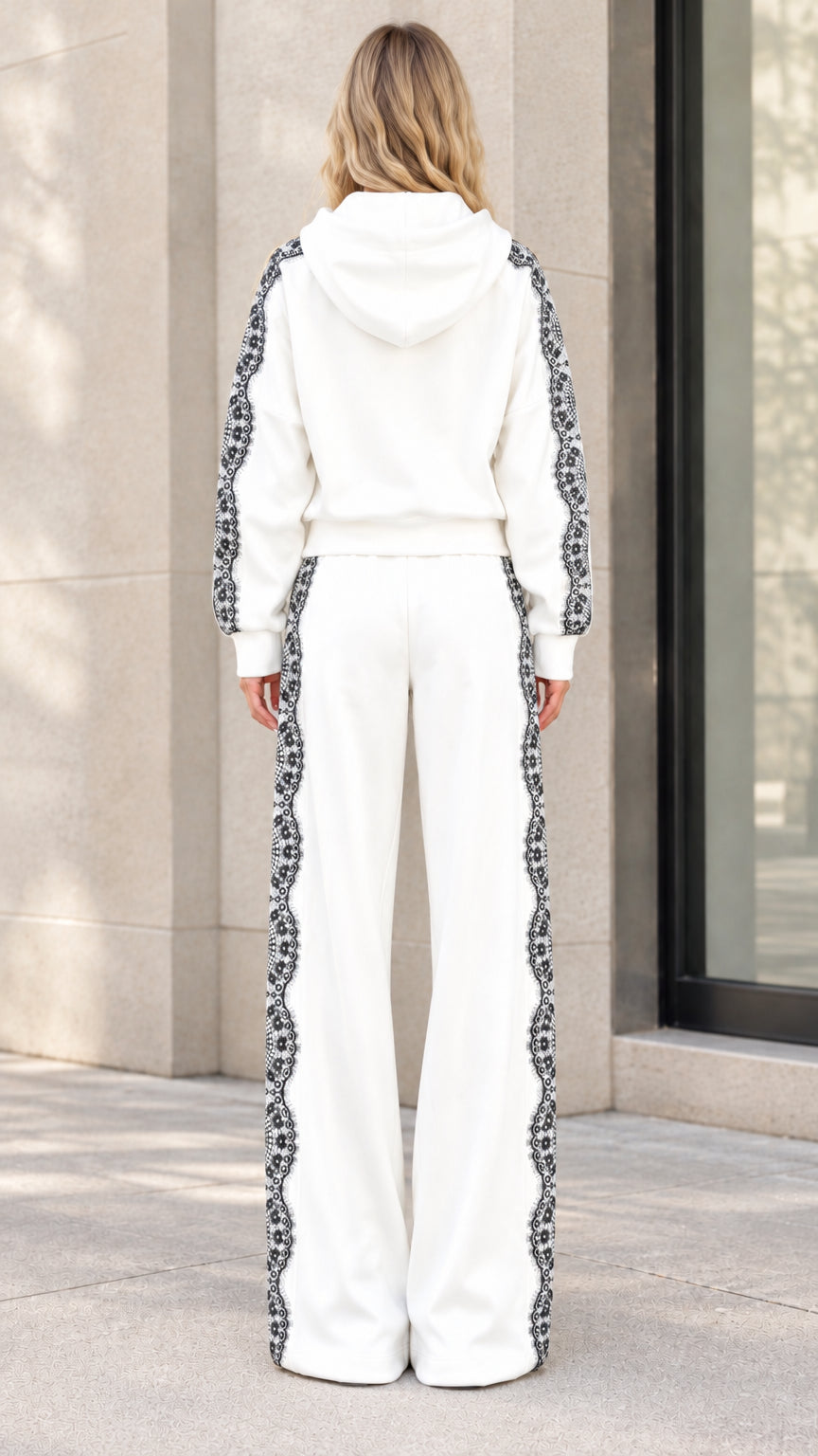 Back view of model wearing white hooded tracksuit set with wide-leg pants