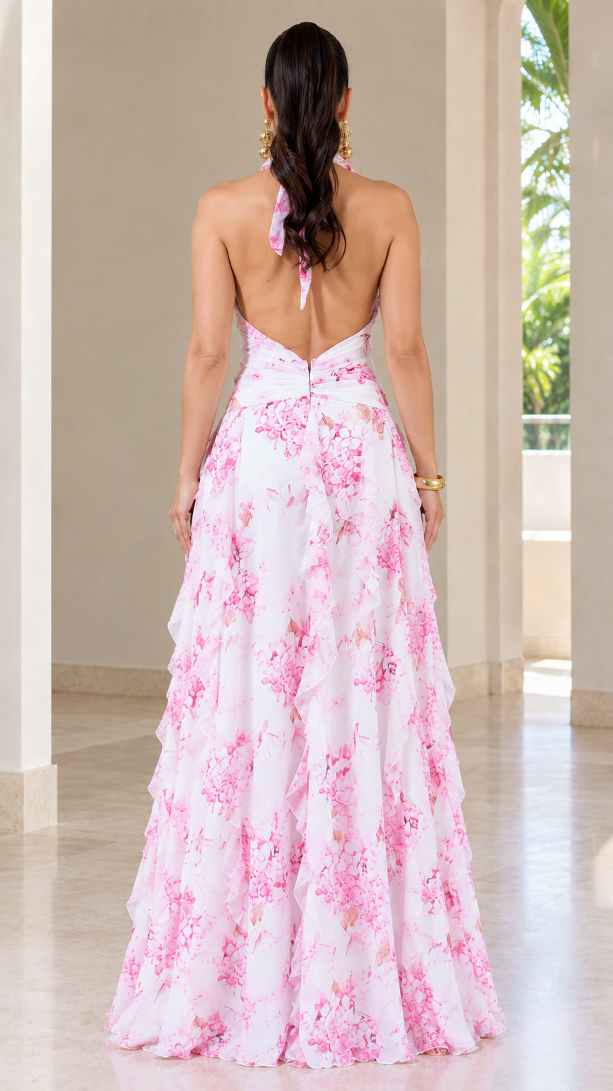 Back view of white floral halter maxi dress showing open back design